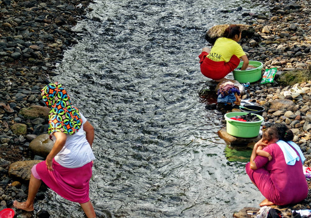 Indonesia - Indonesian ladies washes clothes at the river 