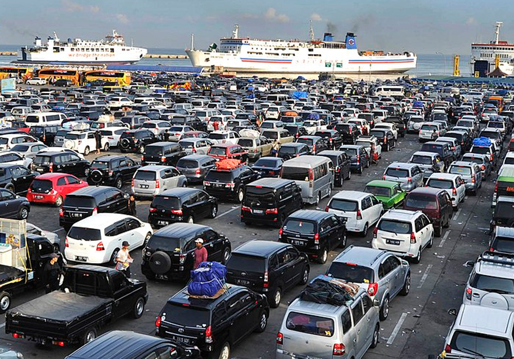 Queued vehicles enter the ferry to Sumatra Island at Merak Harbor